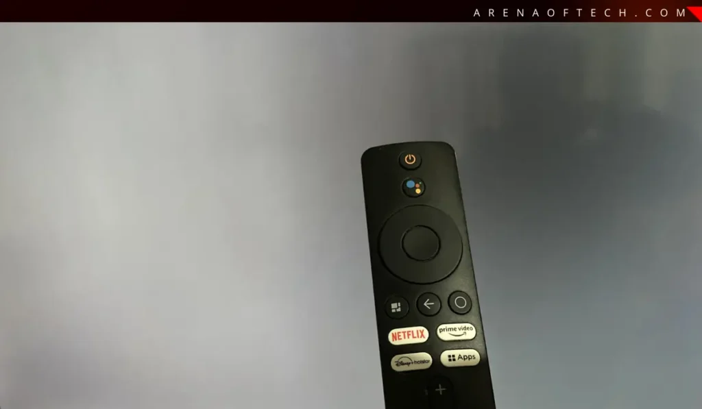 Photo of a Xiaomi Mi TV remote highlighting the Home and Back buttons for a hard reset.